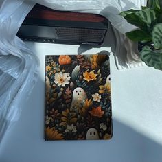 an image of a halloween themed placemat on a table with flowers and pumpkins