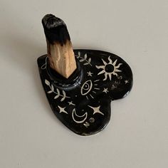 a black and white toothbrush holder with stars, moon and sun designs on it