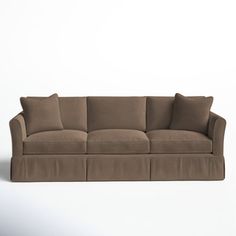 a brown couch sitting on top of a white floor