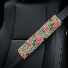 the seat belt is decorated with flowers and leaves in pink, orange, yellow and green colors