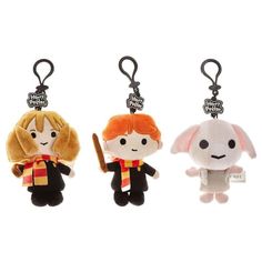 three harry potter keychains, one with an orange hair and the other has a white