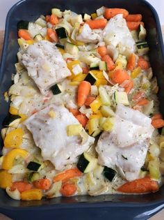 a casserole dish with chicken, carrots and zucchini