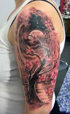 a woman's half sleeve tattoo with flowers on her arm and the moon in the background