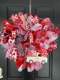 a valentine's day wreath with a truck and hearts on the front door handle