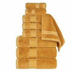 a stack of yellow towels sitting on top of each other