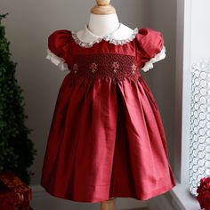 This Red Silk Special Occasion Smocked Dress In Size 24 Months Is Gorgeous!!! The Details Are Exquisite!! The Bodice Has Beautiful Smocking With Lovely Multi Tone Red Rose Bouquets Hand Embroidered Throughout. The Peter Pan Collar Is Made Of Ivory Silk Trimmed With An Ivory Organdy Ruffle. The Short Puff Sleeves Have The Same Beautiful Detail As The Collar. Upper Button Back With Ivory Pearlized Buttons And A Tie Back Sash For A Perfect Fit. Beautifully Made Laura Ashley Dress!! Worn Once Briefly For Studio Portraits-Immaculate, Mint Condition!! 11.5 Inches Across Chest From Underarm Seam To Other Underarm Seam 21 Inches Long From Top Of Shoulder To Bottom Of Hem Matching Romper/Bubble S Casual Red Smocked Dress With Smocked Cuffs, Red Cotton Dress With Smocked Cuffs, Red V-neck Dress With Smocked Bodice, Christmas Smocked Dresses, Formal Baby Dress, Smocked Christmas Dresses Baby, Smocked Christmas Dresses, Pink Toddler Dress, Velvet Holiday Dress