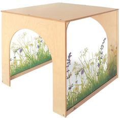 a wooden table with flowers and grass painted on the side, in front of a white background