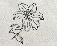 a black and white drawing of a flower on a piece of cloth with stitching