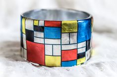 a close up of a colorful bracelet on a white surface