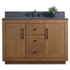 a bathroom vanity with two sinks and wooden cabinets