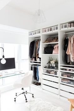 an image of a white closet with clothes and shoes on it's shelves in front of a window