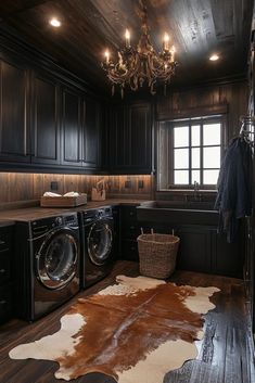 a brown and white cowhide rug in a dark wood laundry room with chandelier