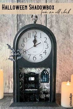 an old fashioned clock with candles around it and the words halloween shadowbox written below