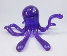 an octopus figurine sitting on top of a white table