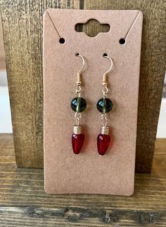 Add this pair of light bulb earrings to get into the festivities!  The green bead with the red bulb make the perfect Christmas earrings!  Super lightweight dangly earrings with gold colored fishhook ear wires. The Perfect Christmas, Dangly Earrings, Christmas Earrings, Green Bead, Fish Hook, Perfect Christmas, Ear Wires, Jewelry Earrings Dangle, Light Bulb