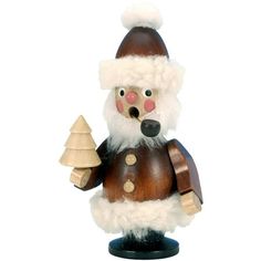 a wooden santa claus figurine holding a christmas tree ornament on a white background