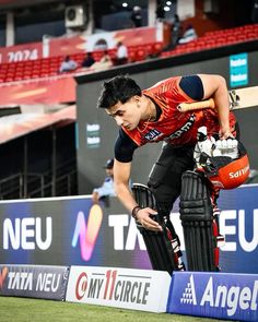 a man standing on top of a cricket field