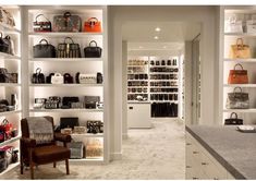 a room filled with lots of purses and handbags on shelves next to a counter