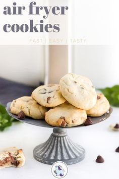 chocolate chip cookies sitting on top of a cake plate with the words air fryer cookies