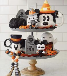 three tiered tray with mickey and minnie mouse figurines on it's sides