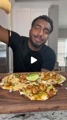 a man sitting at a table with food in front of him