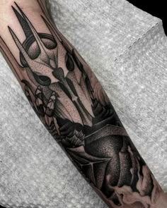 a man's arm with tattoos on it and scissors in the middle of his arm