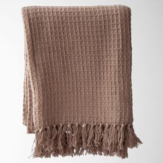 a brown blanket with fringes hanging from it