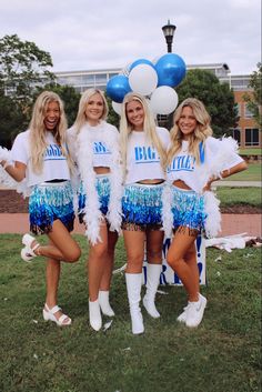 the cheerleaders are posing for a photo in front of some blue and white balloons