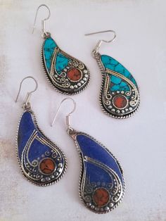 Lapis or Turquoise Tibet Earrings Paisley-shaped Tibetan earrings for a fun and chic Boho look. In your choice of Turquoise or Lapis and both have Coral detail inlay. Each paisley features carefully shaped intricate metal loops and beading and a lovely twisted wire border. The metal used is Tibetan silver alloy but the earring hooks themselves are 925 sterling silver for worry-free wear. This particular style is a little bit on the heavy side, please be aware when ordering. If you have issues we Tibetan Earrings, Malachite Earrings, Heavy Earrings, Twisted Wire, Boho Look, Tibet, Boho Chic, Paisley, Jewelry Design