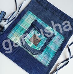 a bag made out of blue jeans with a patchwork design on the front