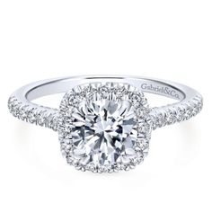 a white gold halo engagement ring with round diamonds