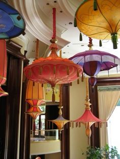 many different colored lamps hanging from the ceiling