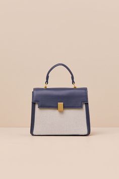 A considered cutie like you will find a million ways to style the Poised Intention Navy and White Handbag! Sleek faux leather shapes this stylish bag that has a flat bottom and a satchel-inspired silhouette with woven panels at the front and back, a flexible top handle, and a top flap with a locking clasp. Roomy interior boasts a zippered sidewall pocket, a second sidewall compartment, and an optional shoulder strap for crossbody wear. Gold-toned hardware throughout. Lined. Bag Measures 8" Wide, Navy Handbag, Navy Purse, White Handbag, Stylish Bag, Business Outfits, Handle Bag, Dublin, Top Handle, Navy And White