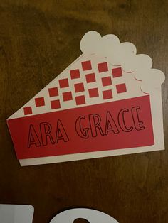 a close up of a piece of paper with the word ara grace on it and a clock next to it