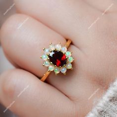 Gemstone : Natural Red Garnet With Ethiopian Opal Metal : 9K Gold / 14K Gold / 18K Gold / 925S Silver Gemstone Shape and Size : Oval 8x6 MM Gemstone Shape and Size :Round 3.00 MM (Ethiopian Opal) Gemstone Weight : 2.50 Cts Metal Weight :  3.20 Gram ACCEPT CUSTOM SERVICE: 1. Accept change main stone type, size : Oval 8x6 MM 2. Accept change other material : This jewelry can also be made in solid gold (14K white/rose/yellow gold...) Please contact me if you have special requests. Thanks for your visiting! Rings Opal Engagement, Gold Women Ring, Rings Opal, January Birthstone Rings, Red Garnet Ring, Birthstone Rings, Opal Engagement Ring, Engagement Ring For Her, Garnet And Gold