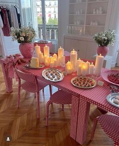 a dining room table set up with red and white gingham cloth