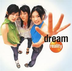 three young women standing next to each other in front of a sign that says dream reality