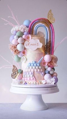 there is a cake decorated with pastel colors