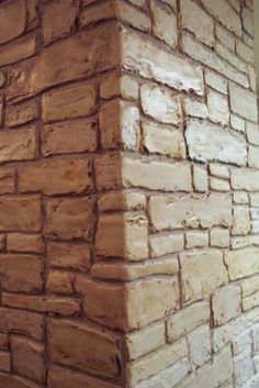 the corner of a brick wall made out of bricks