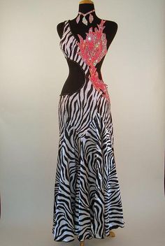 a woman's dress with zebra print on the bottom and pink flowers on the back