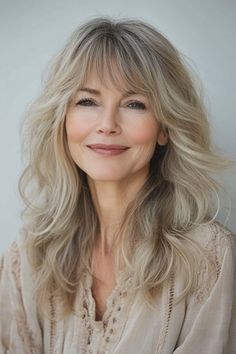 Click for More ➡️ | Save for Later ❤️  This cut blends soft, shaggy layers with a honey blonde color, offering a laid-back, youthful vibe that's easy to style and maintain. (Honey Blonde Soft Shag - Hairstyles For Women Over 50 With Long Hair) Long Blonde Shag With Curtain Bangs, Blonde Hair For Older Women Over 50 Long Hairstyles, Long Blonde Layered Wigs, Blonde Feathered Bangs, Long Blonde Wigs For White Women, Older Women's Hairstyles, Champagne Blonde, Shag Hairstyles, Long Hair With Bangs