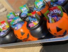 halloween candies are in cups with jack - o'- lantern faces on them