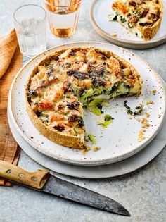 a quiche with broccoli, cheese and other toppings on a plate