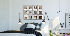 a bedroom with pictures on the wall above the bed and lamps hanging from the ceiling