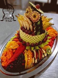 a platter filled with lots of different types of fruits and veggies on top of each other