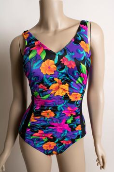 FREE DOMESTIC SHIPPING! <3♥ Cute vintage 1980s bright floral print bathing suit by Maxine of Hollywood!♥ Fun v-neckline and gathering gives it a very flattering look.♥ Neon tropical flower print! Black strip sides. Low scoop back.♥ In great condition! Maxine of Hollywood tag. Nylon/spandex.* measurements *Bust - up to 36"Waist - 24-26"Hips - up to 34"Length - 28"Fits like an XS, smallTagged a vintage 10Nylon/spandex** I do ship worldwide!For more vintage cuteness, check out my store:→ http:// Floral Bathing Suit, Floral Bathing Suits, Vintage Dresses 1960s, 1960's Dress, Tropical Flower, Ribbed Knit Dress, Bright Flowers, Tropical Vacation, One Piece For Women