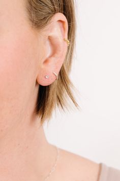 a close up of a person wearing a pair of ear piercings on their ears