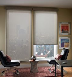 a living room filled with furniture next to a window covered in sheers and shades