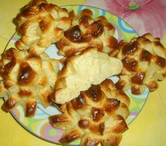 a plate filled with hot cross buns on top of a yellow and blue table