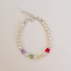 "This beautiful bracelet is made with white freshwater pearls and swarovski butterflies. It is finished with a sterling silver extension chain for longer use.  *photos show this bracelet with various colour butterflies but other colours may be available upon request. S I Z I N G    G U I D E The bracelet should be 3/4\" larger than the child's snug wrist measurement. If you are unable to measure, you may use this guide for approximate bracelet sizing. 0-3 Months; 4\", 3-9 Months; 4.5\", 9-36 Months; 5\", 3-5 Years; 5.5\", 5-8 Years; 6\", 8-12 Years; 6.5\", 13+ Years; 7\",  Other options available on request. PLEASE NOTE; Design is modified according to size." Beaded Pearl Bracelet For Birthday, White Hypoallergenic Pearl Bracelet For Birthday, Hypoallergenic Pearl Bracelet For Birthdays, Swarovski Butterfly, Butterfly Handmade, White Freshwater Pearl, Note Design, Handmade Bracelet, Baby Gift